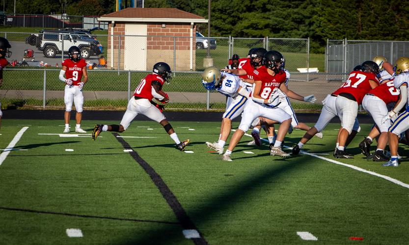 A football player runs the ball